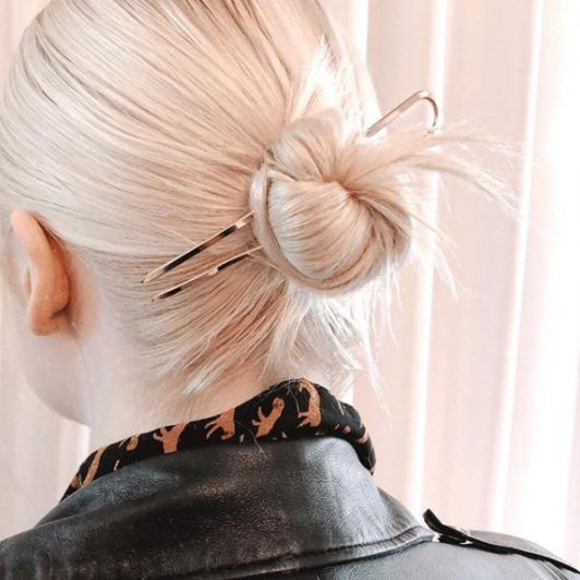 Gładki blond kok z ozdobnymi szpilkami Gładki mały blond kok z metalowymi szpilkami